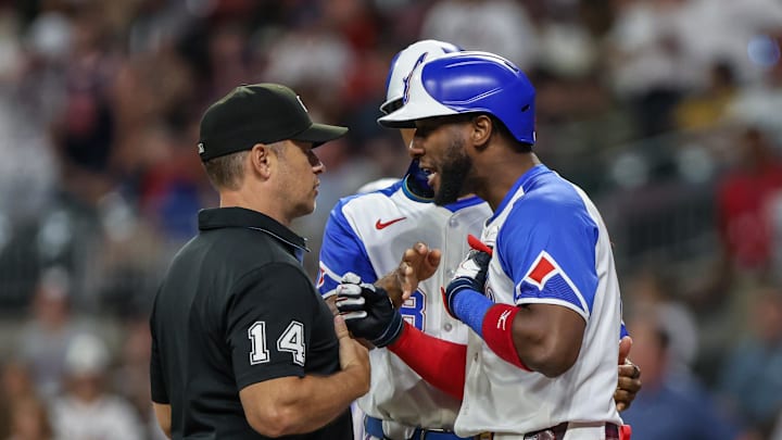 Sep 27, 2025; Cumberland, Georgia, USA; Atlanta Braves outfielder Jurickson Profar (7) speaks to umpire Mark Wegner (14) after a call in the game against the Pittsburgh Pirates during the eighth inning at Truist Park. Mandatory Credit: Jordan Godfree-Imagn Images