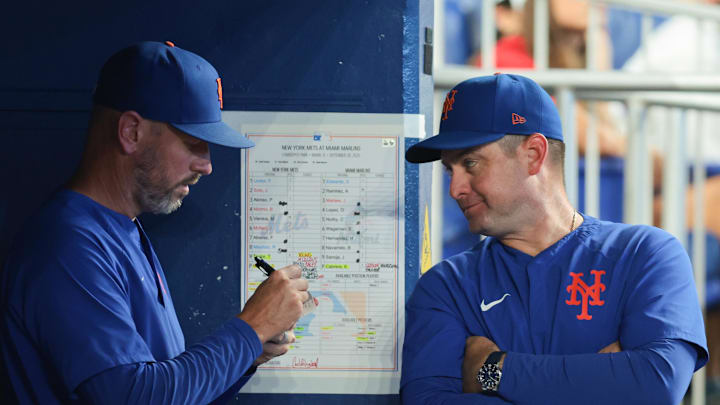 Sep 28, 2025; Miami, Florida, USA; New York Mets manager Carlos Mendoza (64) talks to pitching coach Jeremy Hefner (95) against the Miami Marlins during the eighth inning at loanDepot Park. Mandatory Credit: Sam Navarro-Imagn Images