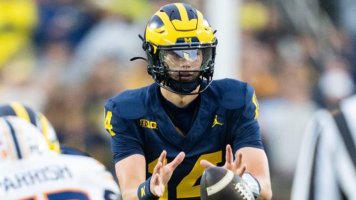 Michigan Wolverines quarterback Tommy Carr (14) receives the ball in the fourth quarter of a game against UTEP at Michigan Stadium in Ann Arbor on Saturday, Sept. 19, 2026. Michigan Wolverines quarterback Tommy Carr (14) receives the ball in the fourth quarter of a game against UTEP at Michigan Stadium in Ann Arbor on Saturday, Sept. 19, 2026.