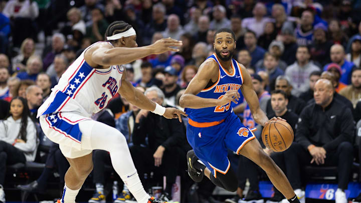 Jan 15, 2025; Philadelphia, Pennsylvania, USA; New York Knicks forward Mikal Bridges (25) dribbles the ball against Philadelphia 76ers forward Guerschon Yabusele (28) during the second quarter at Wells Fargo Center. Mandatory Credit: Bill Streicher-Imagn Images