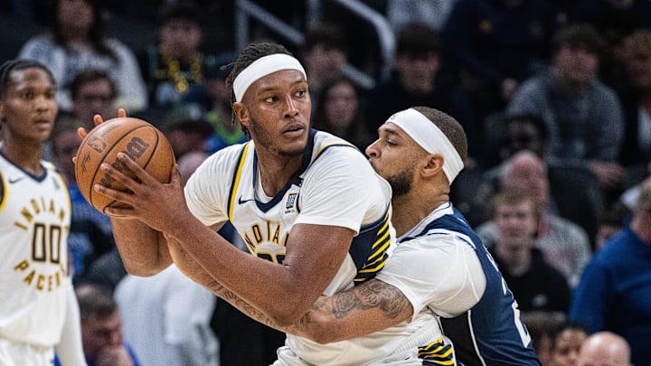 Feb 25, 2024; Indianapolis, Indiana, USA; Indiana Pacers center Myles Turner (33) holds the ball while Dallas Mavericks center Daniel Gafford (21) defends in the second half at Gainbridge Fieldhouse. Mandatory Credit: Trevor Ruszkowski-Imagn Images