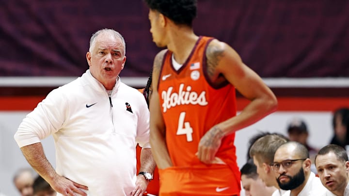 Dec 15, 2024; Blacksburg, Virginia, USA; Virginia Tech Hokies head coach Mike Young talks to guard Rodney Brown Jr. (4) during the first half against the Navy Midshipmen at Cassell Coliseum. Mandatory Credit: Peter Casey-Imagn Images