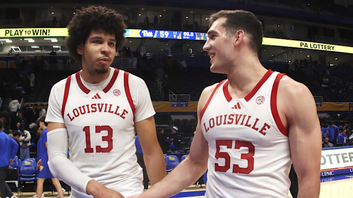 Jan 17, 2026; Pittsburgh, Pennsylvania, USA; Louisville Cardinals forward Sananda Fru (13) and forward Vangelis Zougris (53) celebrate after defeating the Pittsburgh Panthers at the Petersen Events Center. Mandatory Credit: Charles LeClaire-Imagn Images