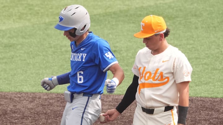Tennessee's Ariel Antigua (2) taps Kentucky's Tyler Bell (6) with the ball as he celebrates hitting a double during an NCAA college baseball game on April 20, 2025, in Knoxville, Tenn.