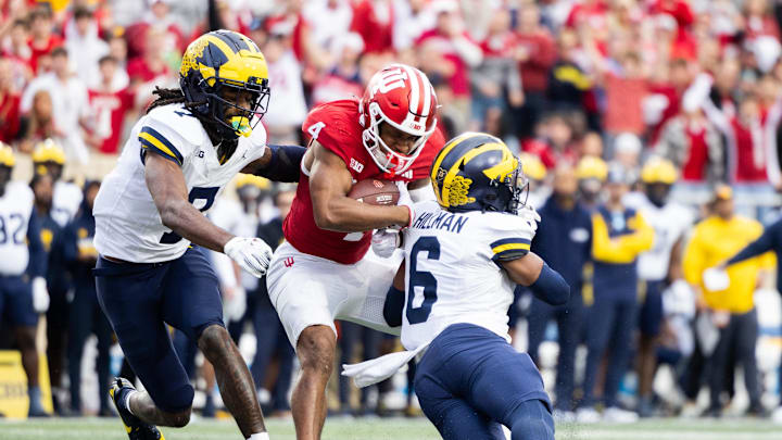Nov 9, 2024; Bloomington, Indiana, USA; Indiana Hoosiers wide receiver Myles Price (4) runs with the ball while Michigan Wolverines defensive back Brandyn Hillman (6) defends in the second quarter at Memorial Stadium. Mandatory Credit: Trevor Ruszkowski-Imagn Images