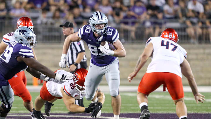 Sep 13, 2024; Manhattan, Kansas, USA; Kansas State Wildcats tight end Will Swanson (83) is tackled by Arizona Wildcats defensive lineman Stanley Ta'ufo'ou (47) and Arizona Wildcats defensive lineman Kevon Darton (45) during the third quarter at Bill Snyder Family Football Stadium. Mandatory Credit: Scott Sewell-Imagn Images