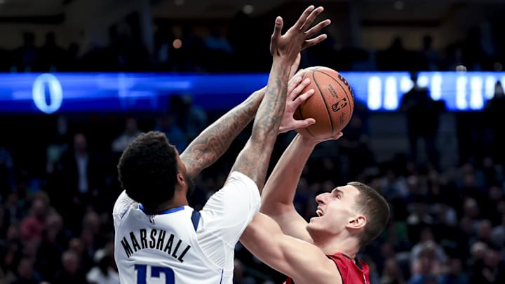 Feb 13, 2025; Dallas, Texas, USA;  Miami Heat forward Nikola Jovic (5) shoots as Dallas Mavericks forward Naji Marshall (13) defends during the second half at American Airlines Center. Mandatory Credit: Kevin Jairaj-Imagn Images