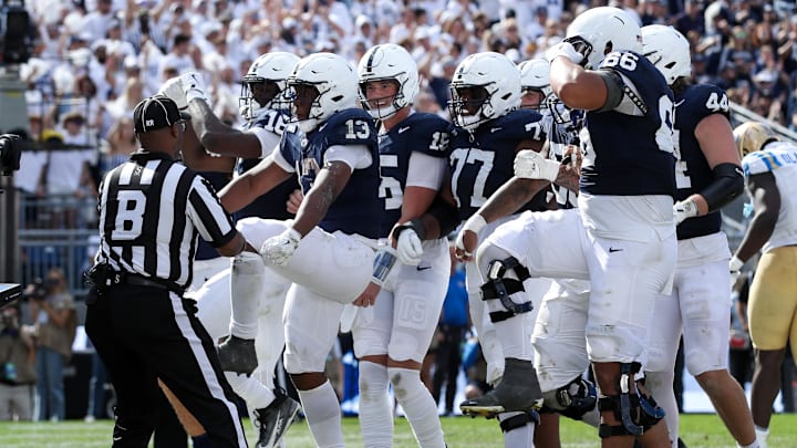 Penn State running back Kaytron Allen (13) celebrates with his teammates after scoring a touchdown during the third quarter against the UCLA Bruins at Beaver Stadium.