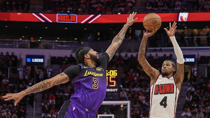Jan 5, 2025; Houston, Texas, USA;  Houston Rockets guard Jalen Green (4) shoots against Los Angeles Lakers forward Anthony Davis (3) in the first quarter at Toyota Center. Mandatory Credit: Thomas Shea-Imagn Images