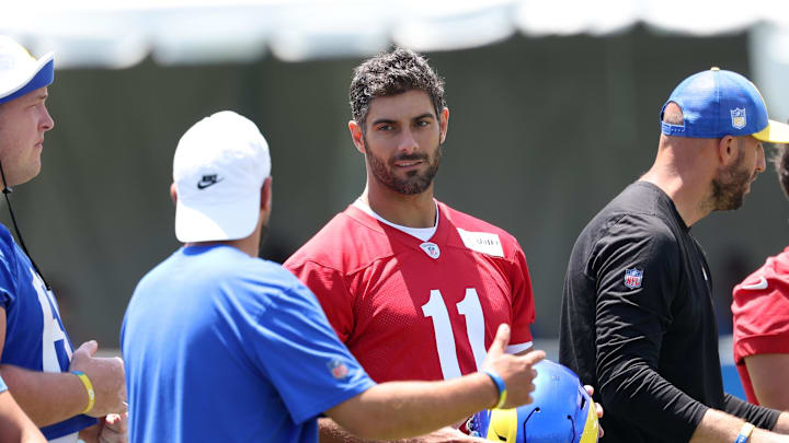 Jul 31, 2024; Los Angeles, CA, USA;  Los Angeles Rams quarterback Jimmy Garoppolo (11) talks with a member of the coaching staff during training camp at Loyola Marymount University. Mandatory Credit: Kiyoshi Mio-Imagn Images