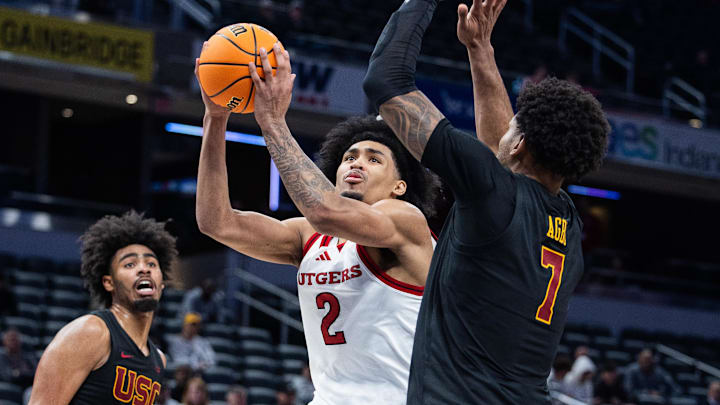 Mar 12, 2025; Indianapolis, IN, USA; Rutgers Scarlet Knights guard Dylan Harper (2) shoots the ball while USC Trojans guard Chibuzo Agbo (7) defends in the second half at Gainbridge Fieldhouse. Mandatory Credit: Trevor Ruszkowski-Imagn Images
