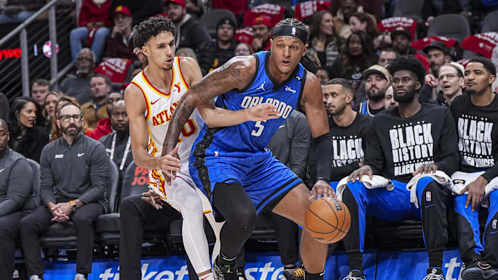 Feb 20, 2025; Atlanta, Georgia, USA; Orlando Magic forward Paolo Banchero (5) is defended by Atlanta Hawks forward Zaccharie Risacher (10) during the first half at State Farm Arena. Mandatory Credit: Dale Zanine-Imagn Images