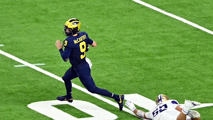 Jan 8, 2024; Houston, TX, USA; Michigan Wolverines quarterback J.J. McCarthy (9) escapes a tackle by