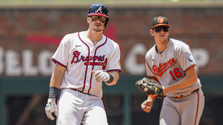 Jul 6, 2025; Cumberland, Georgia, USA; Atlanta Braves catcher Sean Murphy (12) arrives at second base in front of Baltimore Orioles first baseman Coby Mayo (16) after hitting a double during the seventh inning at Truist Park. Mandatory Credit: Dale Zanine-Imagn Images