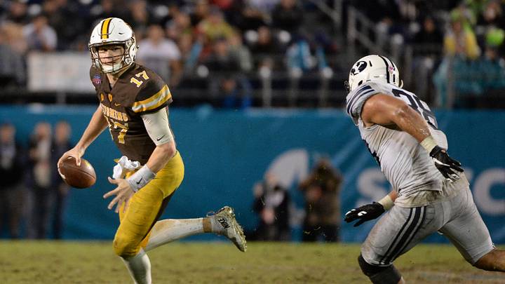 Dec 21, 2016; San Diego, CA, USA; Wyoming Cowboys quarterback Josh Allen (17) runs while pressured by Brigham Young Cougars linebacker Butch Pau'u (38) during the second half at Qualcomm Stadium. BYU won 24-21. Mandatory Credit: Orlando Ramirez-USA TODAY Sports Dec 21, 2016; San Diego, CA, USA; Wyoming Cowboys quarterback Josh Allen (17) runs while pressured by Brigham Young Cougars linebacker Butch Pau'u (38) during the second half at Qualcomm Stadium. BYU won 24-21. Mandatory Credit: Orlando Ramirez-USA TODAY Sports