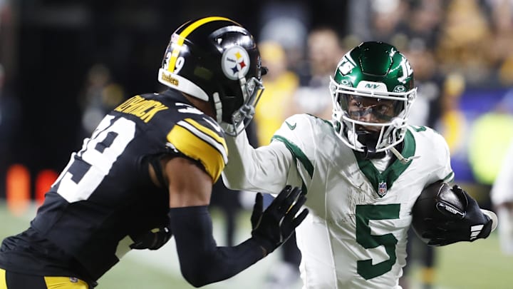 New York Jets wide receiver Garrett Wilson (5) runs after a catch as Pittsburgh Steelers safety Minkah Fitzpatrick (39) defends during the first quarter at Acrisure Stadium.