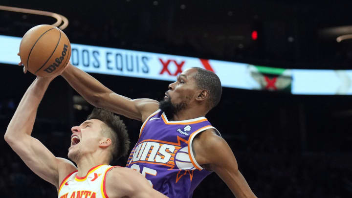 Mar 21, 2024; Phoenix, Arizona, USA; Phoenix Suns forward Kevin Durant (35) blocks a layup attempt by Atlanta Hawks guard Bogdan Bogdanovic (13) during the second half at Footprint Center. Mandatory Credit: Joe Camporeale-USA TODAY Sports