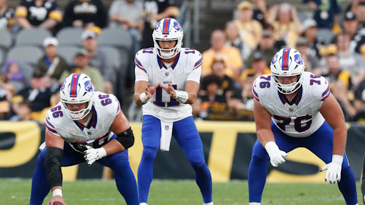 Aug 17, 2024; Pittsburgh, Pennsylvania, USA;  Buffalo Bills center Connor McGovern (66) and quarterback Mitchell Trubisky (11) and guard David Edwards (76) at the line of scrimmage against the Pittsburgh Steelers during the first quarter at Acrisure Stadium. 