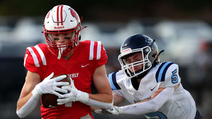 Kimberly High School's Alex Lom (1) pulls down a first down reception against Bay Port High School's Jackson Otradovec (5) during their football game Thursday, August 28, 2025, in Kimberly, Wisconsin. Kimberly won 23-7.