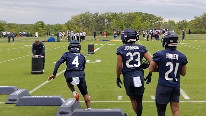 D'Andre Swift runs through individual practice under the watch of backs coach Eric Bieniemy.