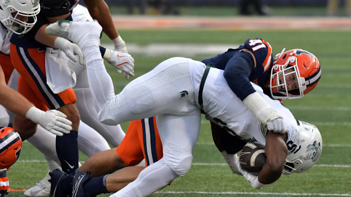 Nov 16, 2024; Champaign, Illinois, USA; Illinois Fighting Illini linebacker James Kreutz (41) tackles Michigan State Spartans running back Nate Carter (5) during the second half at Memorial Stadium. Mandatory Credit: Ron Johnson-Imagn Images