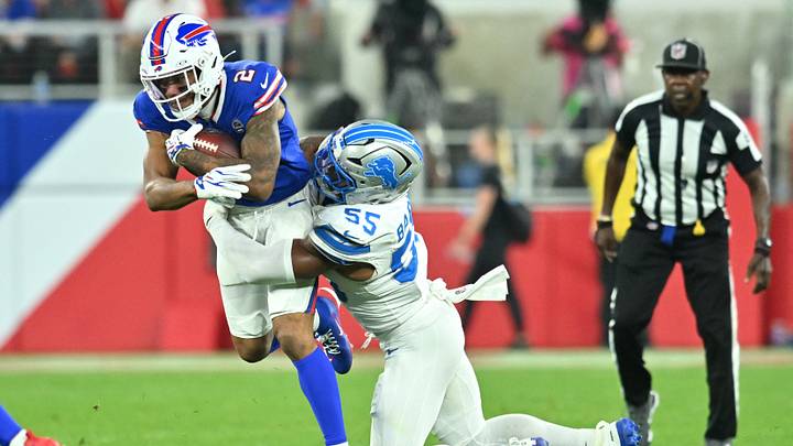 Sep 17, 2026; Orchard Park, New York, USA;  Detroit Lions linebacker Derrick Barnes (55) tackles Buffalo Bills wide receiver D.J. Moore (2) during the first half at New Highmark Stadium.