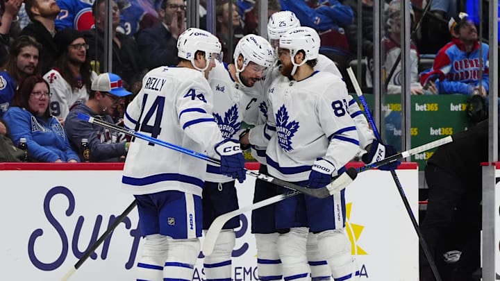 Jan 12, 2026; Denver, Colorado, USA; Toronto Maple Leafs center Auston Matthews (34) celebrates his goal with defenseman Morgan Rielly (44),right wing William Nylander (88), and defenseman Brandon Carlo (25) in the third period against the Colorado Avalanche at Ball Arena. Mandatory Credit: Ron Chenoy-Imagn Images