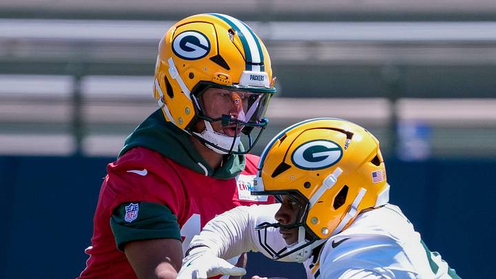 Green Bay Packers quarterback Kyron Drones (13) hands the ball to running back MarShawn Lloyd (32) during practice on Tuesday, June 2, 2026, at Ray Nitschke Field in Ashwaubenon, Wis. 
Tork Mason/USA TODAY NETWORK-Wisconsin