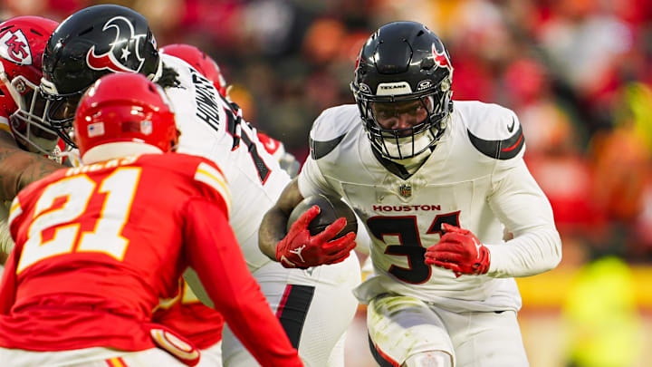 Jan 18, 2025; Kansas City, Missouri, USA; Houston Texans running back Dameon Pierce (31) runs the ball against Kansas City Chiefs safety Jaden Hicks (21) during the second half in a 2025 AFC divisional round game at GEHA Field at Arrowhead Stadium. Mandatory Credit: Jay Biggerstaff-Imagn Images