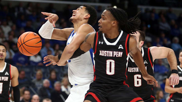 Dec 30, 2023; Memphis, Tennessee, USA; Memphis Tigers forward Nicholas Jourdain (2) looses control of the ball against Austin Peay's DeMarcus Sharp (0). 