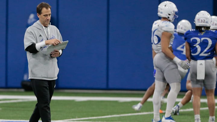Kansas quarterback coach Jim Zebrowski reviews notes during Tuesday morning's practice within the Indoor Football Facility. Kansas quarterback coach Jim Zebrowski reviews notes during Tuesday morning's practice within the Indoor Football Facility.
