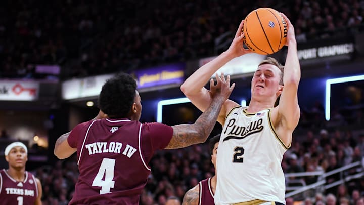 Texas A&M Aggies guard Wade Taylor IV (4) fouls Purdue Boilermakers guard Fletcher Loyer (2) 