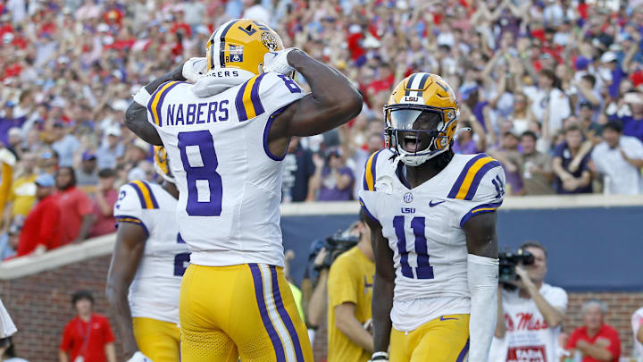Sep 30, 2023; Oxford, Mississippi, USA; LSU Tigers wide receiver Brian Thomas Jr. (11) reacts with LSU Tigers wide receiver Malik Nabers (8) after a touchdown during the first half at Vaught-Hemingway Stadium. Mandatory Credit: Petre Thomas-Imagn Images