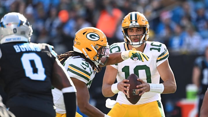 Dec 24, 2023; Charlotte, North Carolina, USA; Green Bay Packers quarterback Jordan Love (10) looks to avoid Brian Burns (0) who is in hot pursuit.