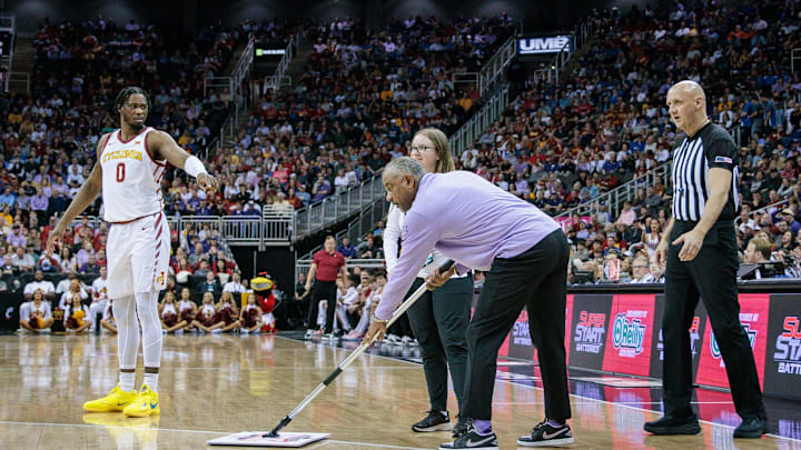 Mar 14, 2024; Kansas City, MO, USA; Kansas State Wildcats coach Jerome Tang cleans the floor during a break in play of the first half of the game Iowa State Cyclones at T-Mobile Center. Mandatory Credit: William Purnell-Imagn Images