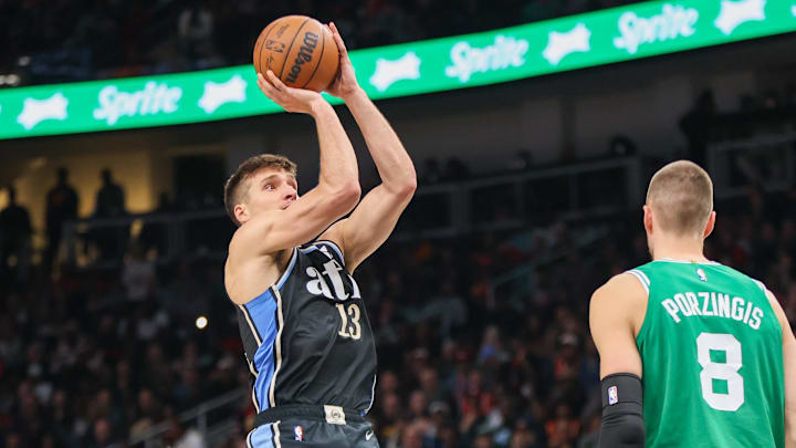 Mar 25, 2024; Atlanta, Georgia, USA; Atlanta Hawks guard Bogdan Bogdanovic (13) shoots against the Boston Celtics in the second half at State Farm Arena. Mandatory Credit: Brett Davis-Imagn Images