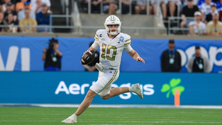 Dec 27, 2025; Orlando, FL, USA; Georgia Tech Yellow Jackets quarterback Haynes King (10) runs out of the pocket against the BYU Cougars during the first half at Camping World Stadium. Mandatory Credit: Kim Klement Neitzel-Imagn Images