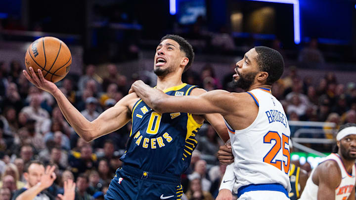Feb 11, 2025; Indianapolis, Indiana, USA; Indiana Pacers guard Tyrese Haliburton (0) shoots the ball while New York Knicks forward Mikal Bridges (25) defends in the first half at Gainbridge Fieldhouse. Mandatory Credit: Trevor Ruszkowski-Imagn Images