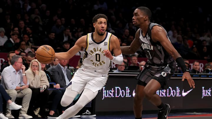 Dec 4, 2024; Brooklyn, New York, USA; Indiana Pacers guard Tyrese Haliburton (0) drives to the basket against Brooklyn Nets guard Shake Milton (7) during the second quarter at Barclays Center. Mandatory Credit: Brad Penner-Imagn Images