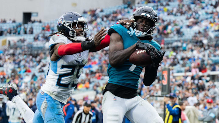 Dec 29, 2024; Jacksonville, Florida, USA; Jacksonville Jaguars wide receiver Brian Thomas Jr (7) catches the ball for a touchdown against Tennessee Titans cornerback Jarvis Brownlee Jr. (29) in the fourth quarter at EverBank Stadium. Mandatory Credit: Jeremy Reper-Imagn Images Dec 29, 2024; Jacksonville, Florida, USA; Jacksonville Jaguars wide receiver Brian Thomas Jr (7) catches the ball for a touchdown against Tennessee Titans cornerback Jarvis Brownlee Jr. (29) in the fourth quarter at EverBank Stadium. Mandatory Credit: Jeremy Reper-Imagn Images