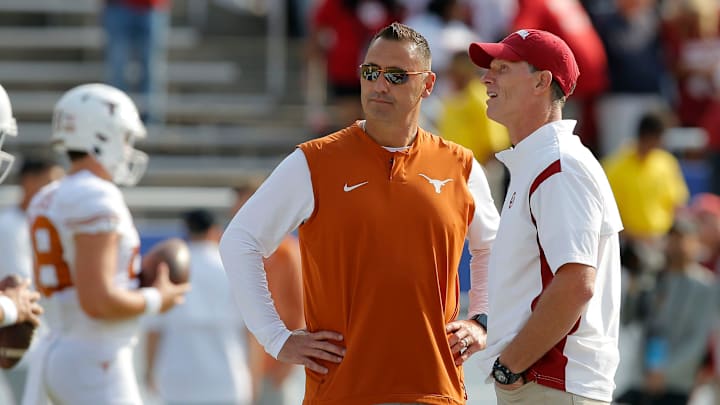Oklahoma Sooners head coach Brent Venables, at right, and Texas Longhorns head coach Steve Sarkisian talk before the Red River Showdown college football game between the University of Oklahoma (OU) and Texas at the Cotton Bowl in Dallas, Saturday, Oct. 8, 2022.

Lx15407