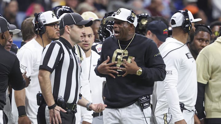 Dec 28, 2024; San Antonio, TX, USA; Colorado Buffaloes head coach Deion Sanders reacts with an official after a play during the second quarter against the Brigham Young Cougars at Alamodome. Mandatory Credit: Troy Taormina-Imagn Images