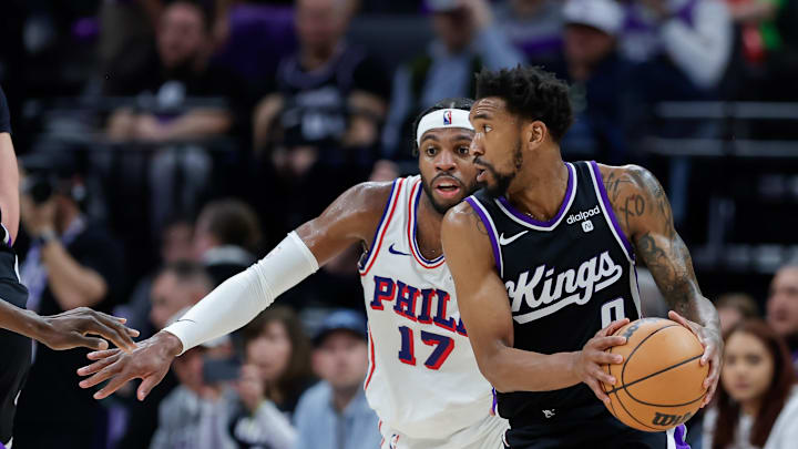 Mar 25, 2024; Sacramento, California, USA; Sacramento Kings guard Malik Monk (0) controls the ball against Philadelphia 76ers guard Buddy Hield (17) during the second quarter at Golden 1 Center. Mandatory Credit: Sergio Estrada-Imagn Images