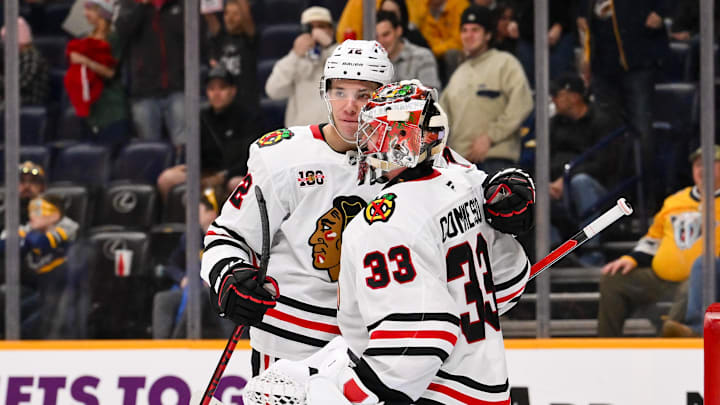 Jan 10, 2026; Nashville, Tennessee, USA;  Chicago Blackhawks goaltender Drew Commesso (33) celebrates the win with defenseman Alex Vlasic (72) against the Nashville Predators during the third period at Bridgestone Arena. Mandatory Credit: Steve Roberts-Imagn Images