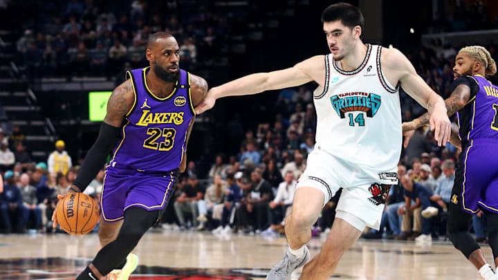 Nov 6, 2024; Memphis, Tennessee, USA; Los Angeles Lakers forward LeBron James (23) drives to the basket as Memphis Grizzlies center Zach Edey (14) defends during the first half at FedExForum. Mandatory Credit: Petre Thomas-Imagn Images