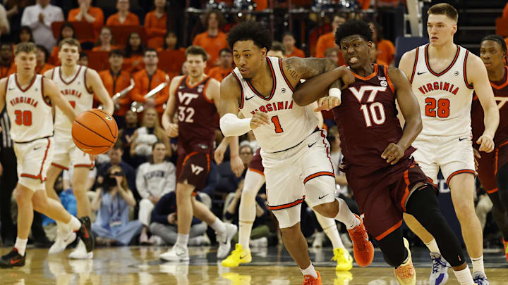 Mar 7, 2026; Charlottesville, Virginia, USA; Virginia Cavaliers guard Malik Thomas (1) and Virginia Tech Hokies guard Tyler Johnson (10) chase a loose ball in the first half at John Paul Jones Arena. Mandatory Credit: Geoff Burke-Imagn Images