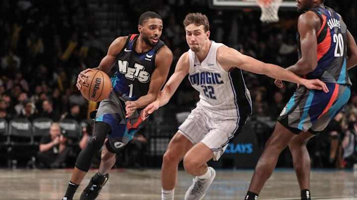 Dec 2, 2023; Brooklyn, New York, USA;  Brooklyn Nets forward Mikal Bridges (1) drives past Orlando Magic forward Franz Wagner (22) in the third quarter at Barclays Center. Mandatory Credit: Wendell Cruz-USA TODAY Sports