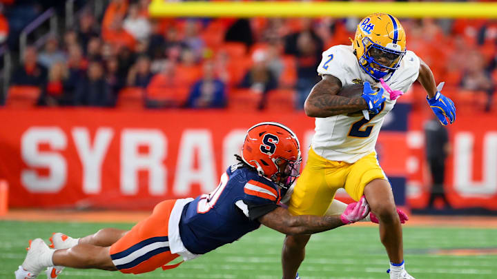 Oct 18, 2025; Syracuse, New York, USA; /Pittsburgh Panthers wide receiver Kenny Johnson (2) runs with the ball as Syracuse Orange defensive back Davien Kerr (10) makes a diving tackle attempt during the first half at the JMA Wireless Dome. Mandatory Credit: Rich Barnes-Imagn Images Oct 18, 2025; Syracuse, New York, USA; /Pittsburgh Panthers wide receiver Kenny Johnson (2) runs with the ball as Syracuse Orange defensive back Davien Kerr (10) makes a diving tackle attempt during the first half at the JMA Wireless Dome. Mandatory Credit: Rich Barnes-Imagn Images