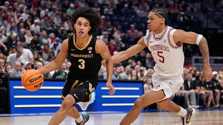 Vanderbilt guard Tyler Tanner (3) drives around Arkansas guard Darius Acuff Jr. (5) during the first half of the SEC tournament championship game at Bridgestone Arena in Nashville, Tenn., Sunday, March 15, 2026. Vanderbilt guard Tyler Tanner (3) drives around Arkansas guard Darius Acuff Jr. (5) during the first half of the SEC tournament championship game at Bridgestone Arena in Nashville, Tenn., Sunday, March 15, 2026.