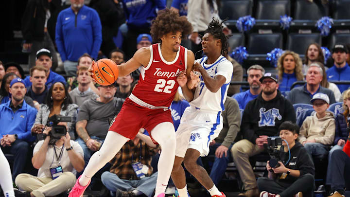 Feb 9, 2025; Memphis, Tennessee, USA; Temple Owls forward Elijah Gray (22) drives against Memphis Tigers guard PJ Carter (7) during the first half at FedExForum. Mandatory Credit: Wesley Hale-Imagn Images